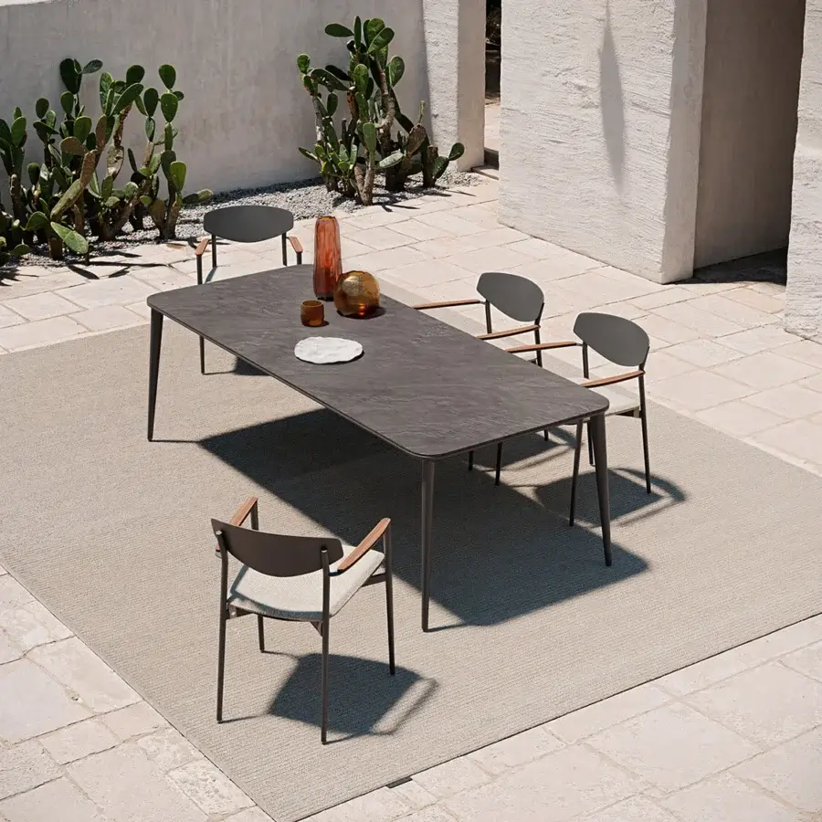 Elegant Atmosphera Origami armchair with a matte dark aluminum shell and warm natural teak armrests