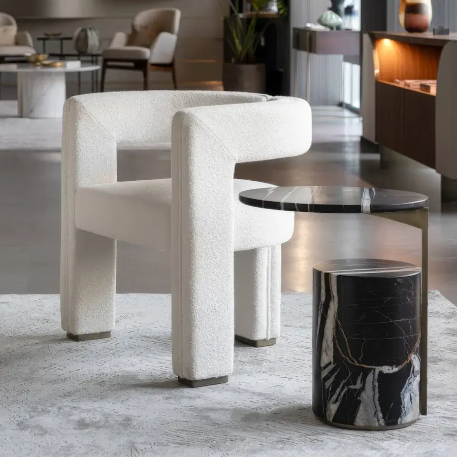 Harmonious Capital Mirage armchair upholstered in textured off-white bouclé with dark metal accents and a matte finish