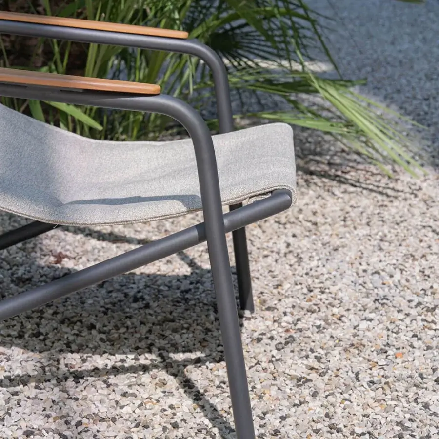 Exceptional Atmosphera Zante lounge chair with a dark gray aluminum frame and light gray textilene seat built with warm wood armrest accents