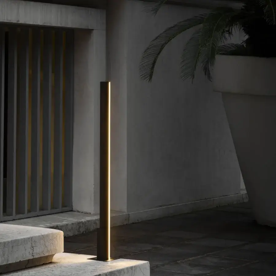 Elegant Contardi Fly Outdoor floor lamp in dark gray matte metal emits a warm yellow glow with architectural clarity