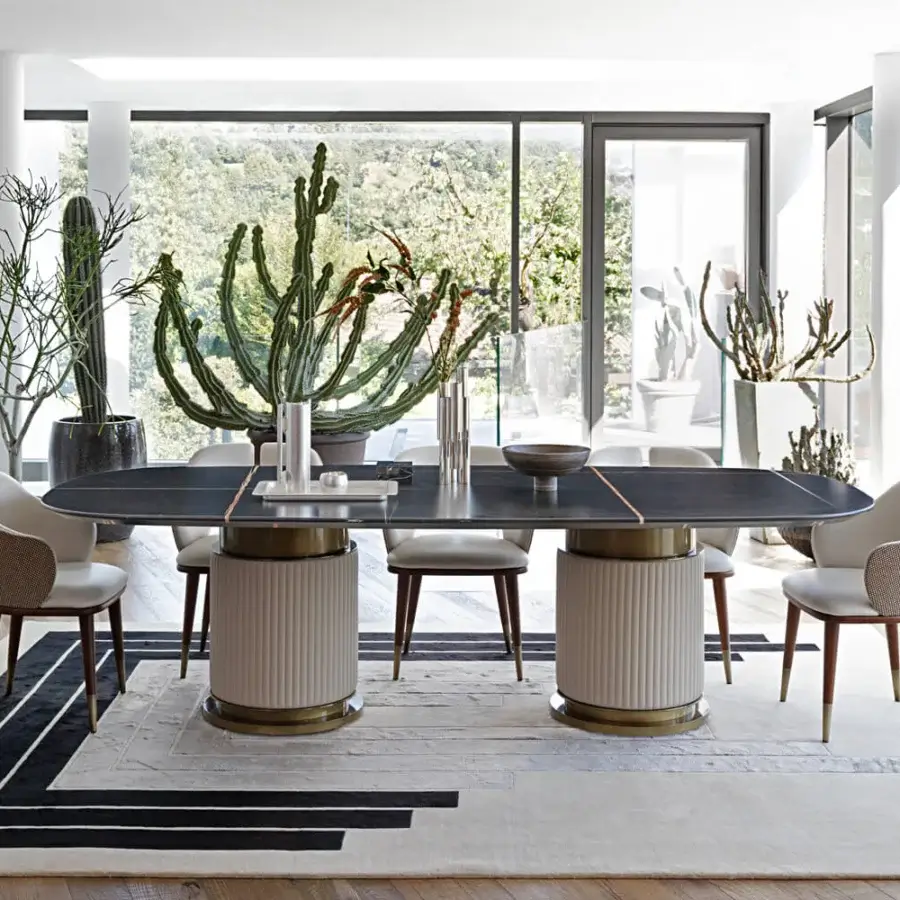 Elegant Capital Rock table with shaped dark gray marble top and quilted leather upholstery with brass details