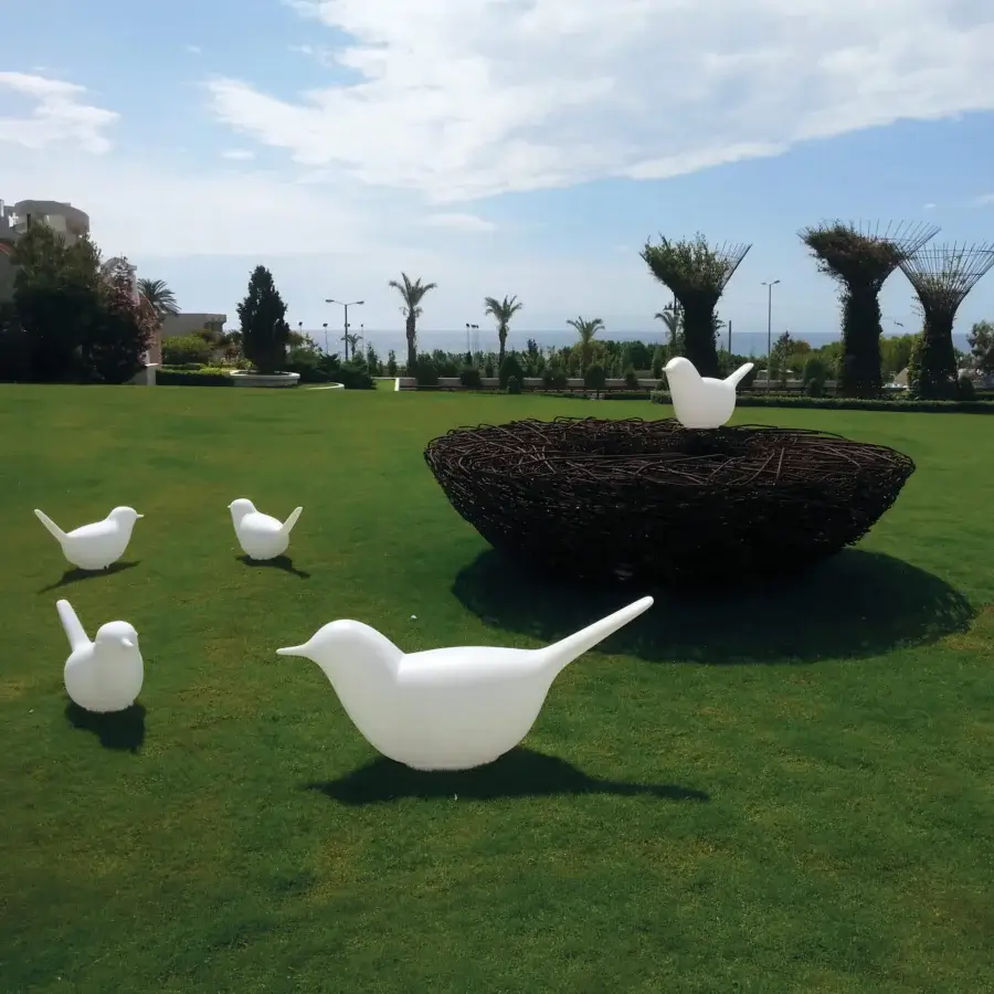 Elegant Serralunga Paloma & Pulcino sculpture set crafted in white glossy LLDPE with a dark brown textured nest