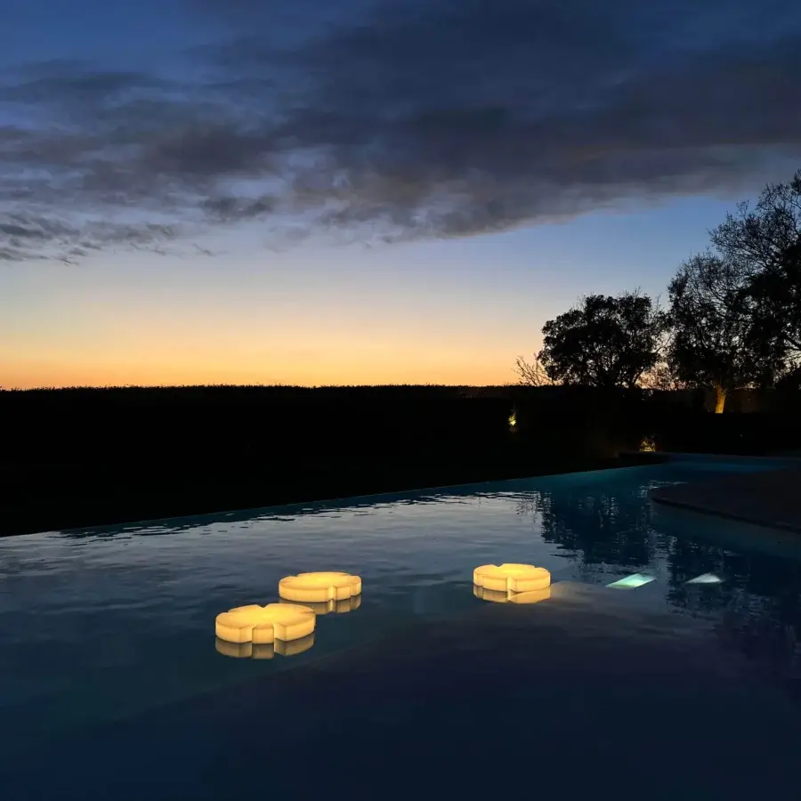 Distinguished Serralunga Fiore Di Loto floating table with floral silhouette crafted from opaline LLDPE and wireless LED lighting