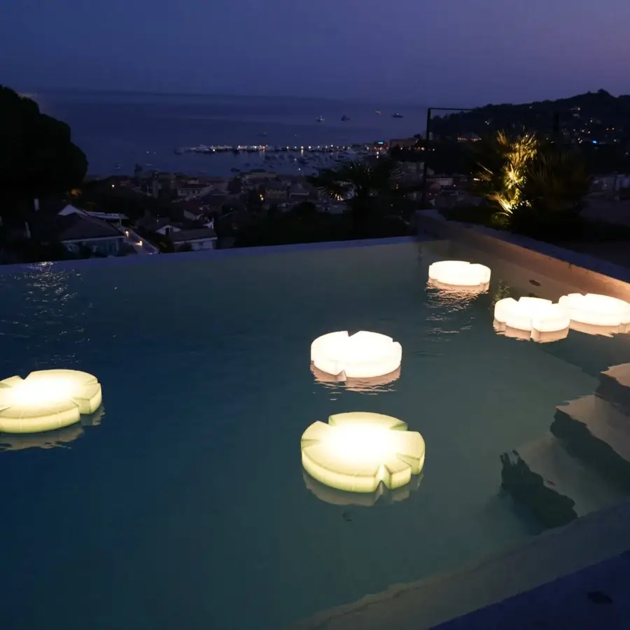 Distinguished Serralunga Fiore Di Loto floating table crafted from LLDPE in pale yellow with opaline finish and integrated neutral LED lighting