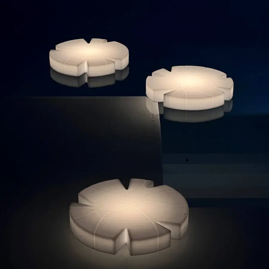 Elegant Serralunga Fiore Di Loto floating table in opaline LLDPE with integrated neutral LED lighting