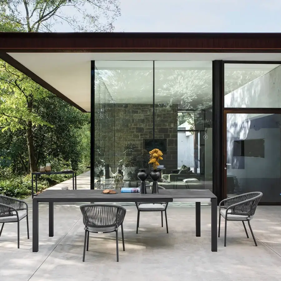 Elegant Atmosphera Bridge extendable table crafted with a dark gray stoneware top and aluminum base embodies a sophisticated industrial aesthetic