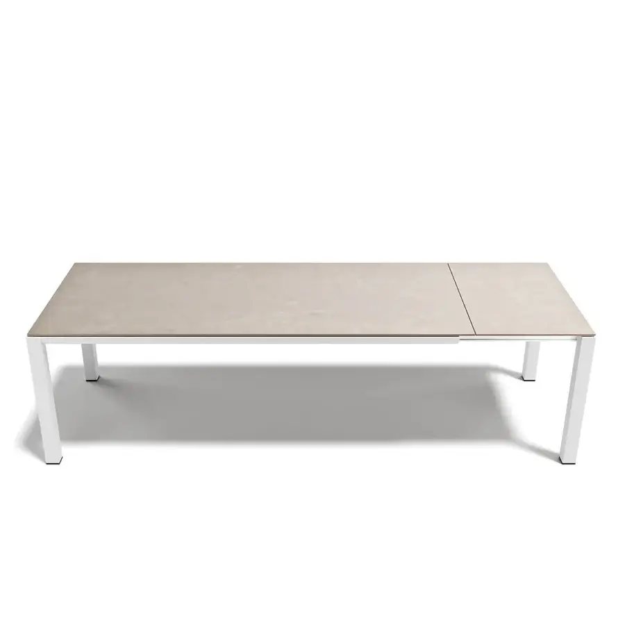 Elegant Atmosphera Bridge extendable table built with light beige stoneware and white aluminum delivering a minimalist aesthetic
