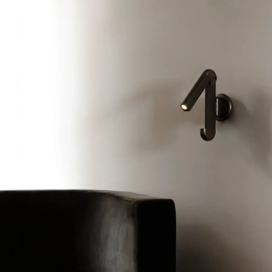 Exceptional Contardi Picchio wall lamp crafted in Italy with a matte dark bronze metal form and pivoting cylindrical fixture