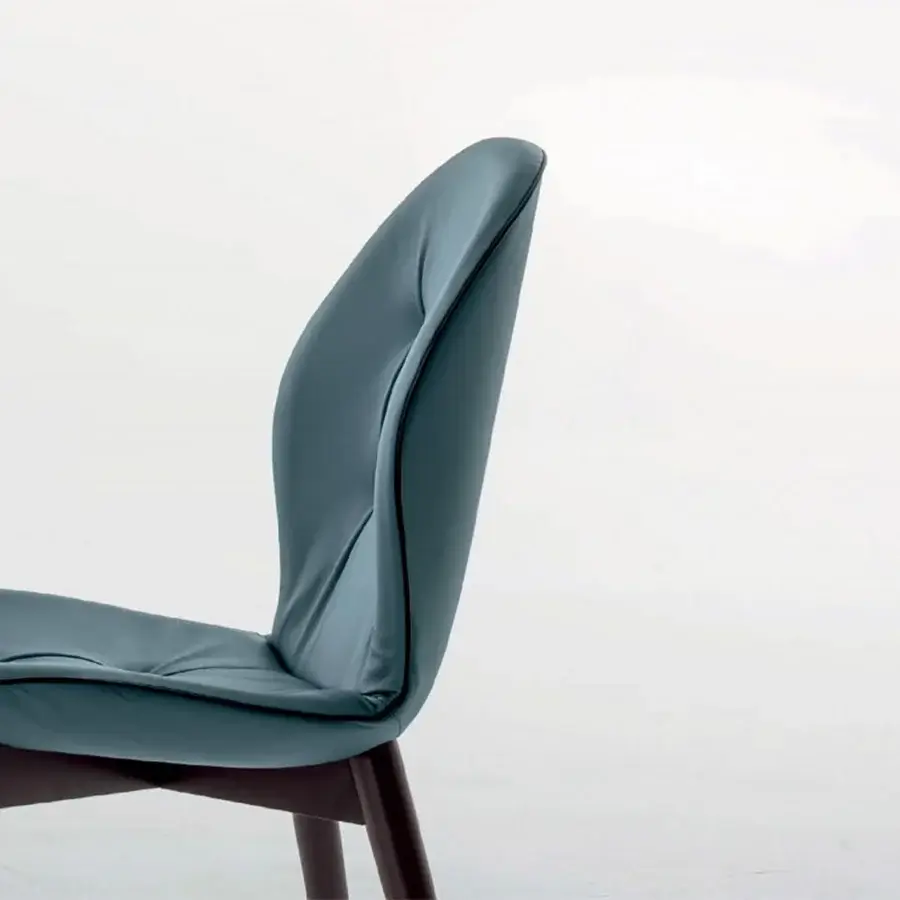 Superior Tonin Casa Sorrento chair with ash wood, dark walnut finish and muted teal leather upholstery showcasing tailored creasing