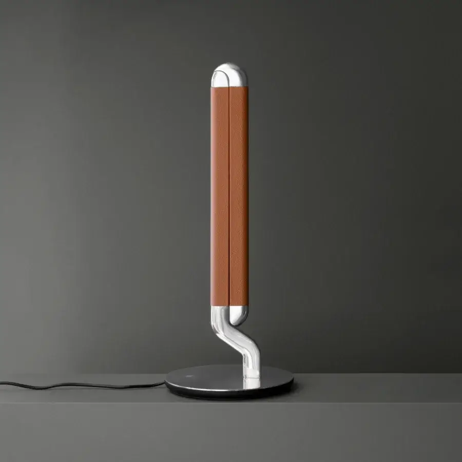 Distinguished Contardi Picchio lamp reimagines illumination with a curved form and warm brown textile shade crafted in polished metal