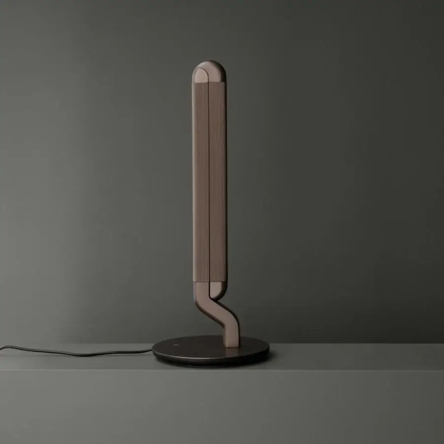 Elegant Contardi Picchio lamp reimagines lighting as sculpture with a gracefully curved, bronze-toned metal body and satin finish