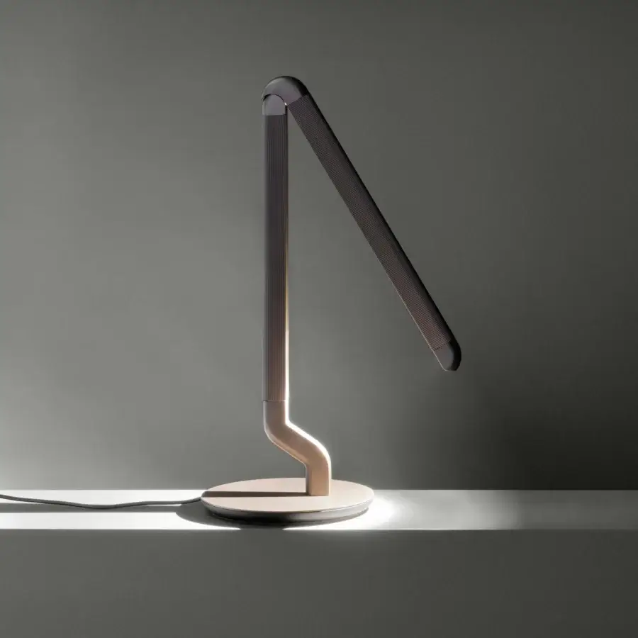 Exceptional Contardi Picchio lamp embodies sculptural design with a slender bronze metal frame and creamy beige base with a satin finish