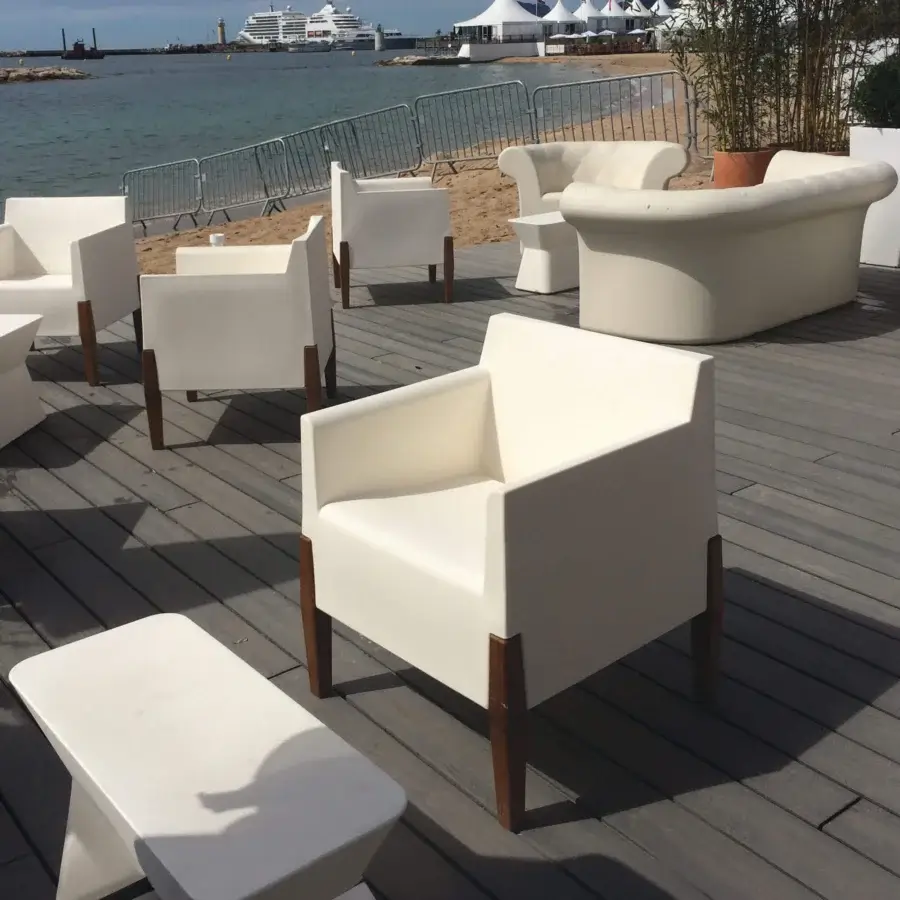 Elegant Serralunga Kubrick lounge chair built in white LLDPE with smooth matte finish and solid Iroko wood legs