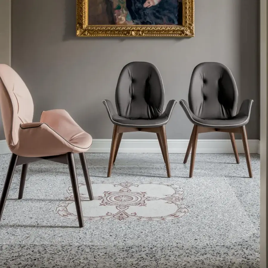 Elegant Tonin Casa Sorrento armchair with embracing form and dark gray matte leather upholstery in medium-brown oak finish