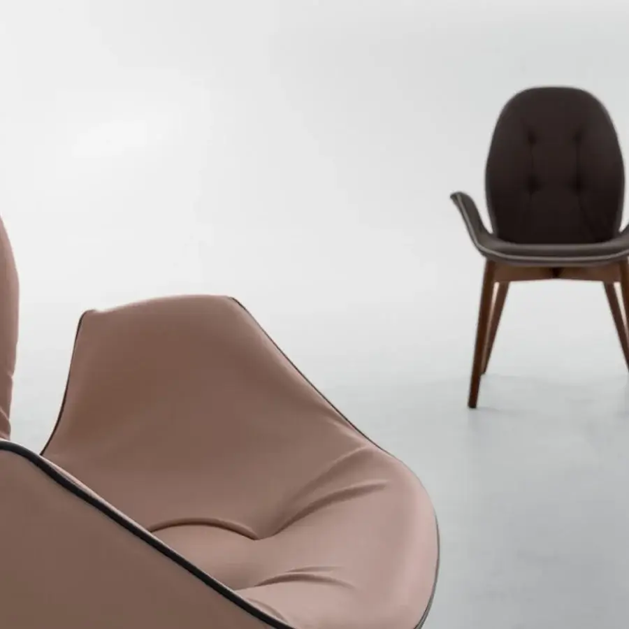 Exceptional Tonin Casa Sorrento armchair with curved form and muted brown leather upholstery in warm oak finish