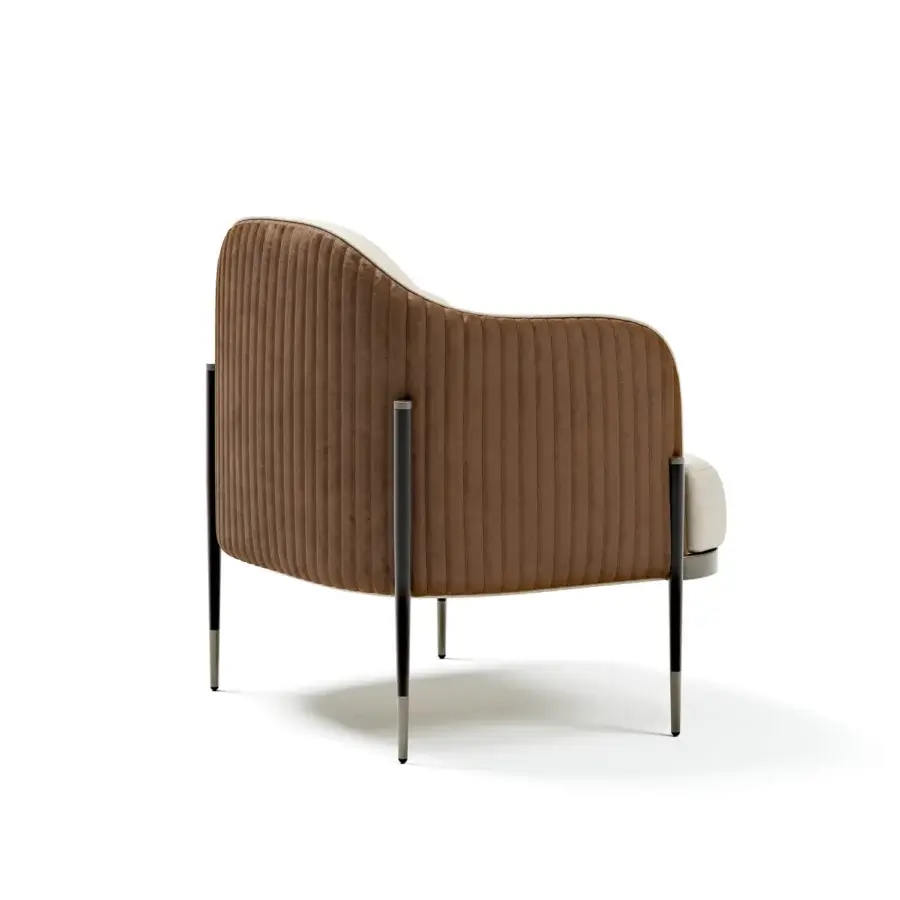 Sophisticated Capital Oxford lounge chair with warm brown ribbed textile, light cushions, quilted leather backrest and dark metal legs