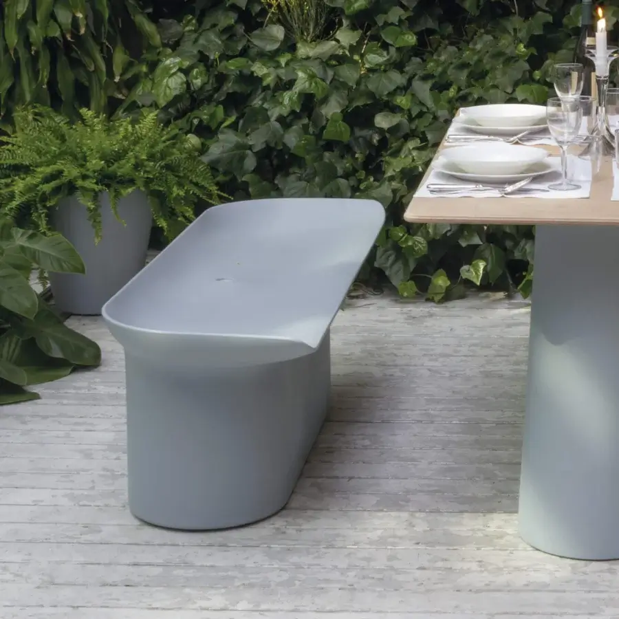 Sophisticated Serralunga Luba bench crafted in muted grey-blue LLDPE plastic with a suede-like finish and organically curved silhouette