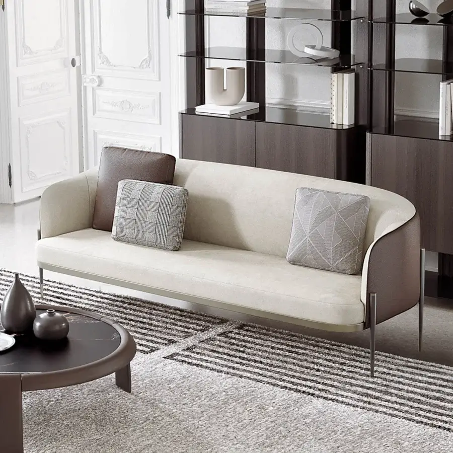 Refined Capital Oxford sofa upholstered in smooth beige textile with quilted leather, built with a slender light-toned metal base and contrasting cushions