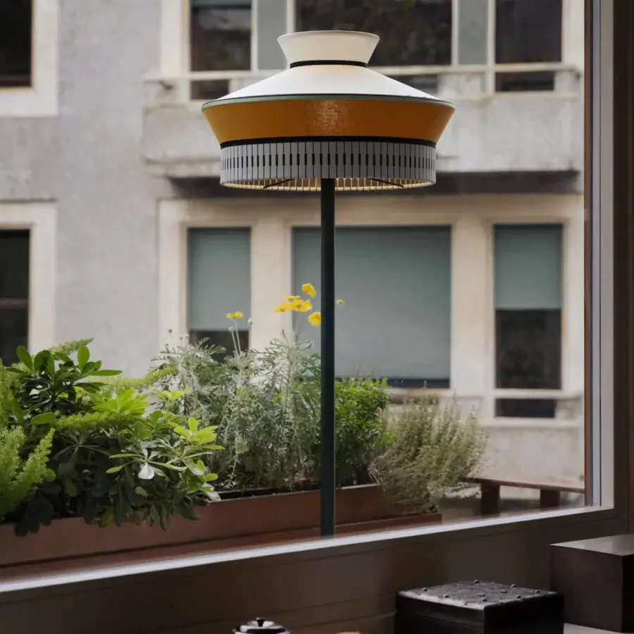 Exceptional Contardi Calypso Outdoor Floor Lamp with tiered shades in yellow and black-and-white stripe crafted in weather-resistant metal with a marble side table