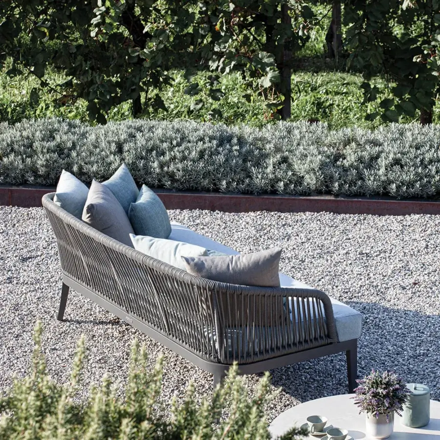 Lavish Atmosphera Dream 2.0 sofa with a dark gray metal frame and plush gray cushions built with hand-woven rope detailing