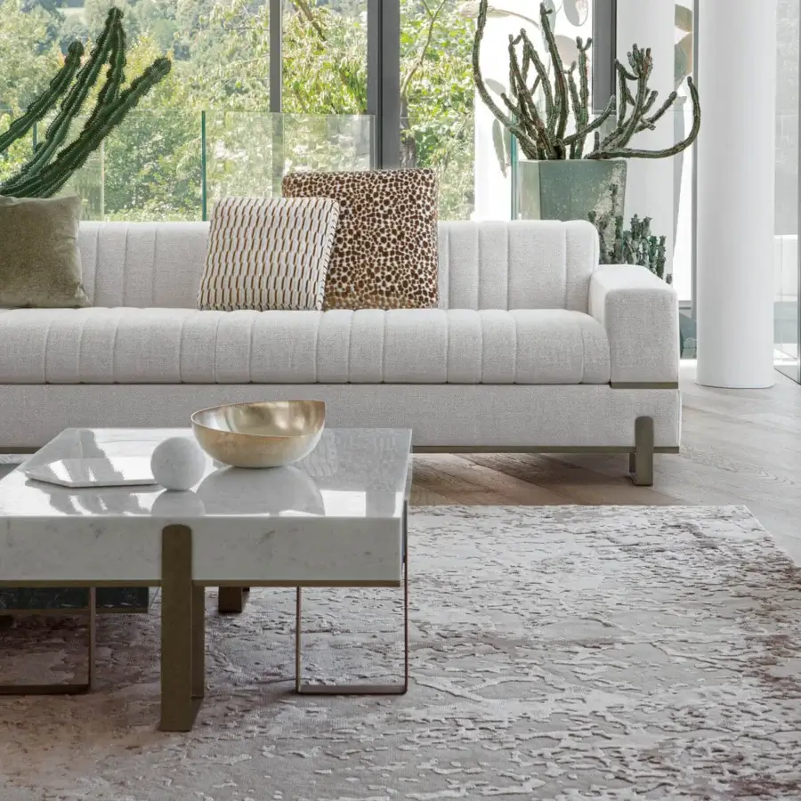 Elegant Capital Grand coffee table with cool white marble tops exhibiting subtle grey veining and slender brass tone metal legs