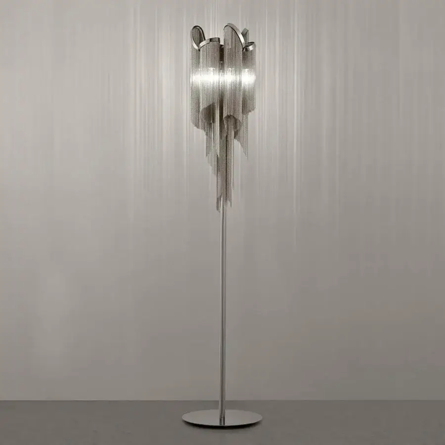 Silver metallic structure holds descending reflective strips forming a cascading waterfall shape against a gray striated background