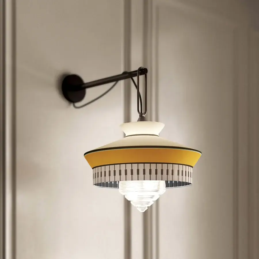 Superior Contardi Calypso Wall Lamp lighting with a dark-toned metal arm and shade in warm yellow and white geometric patterns