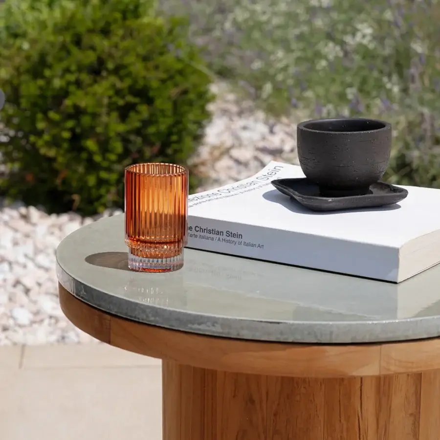 Elegant Atmosphera Frisbee side table with a clear glass top and satin-finish teak base crafted for open-air living
