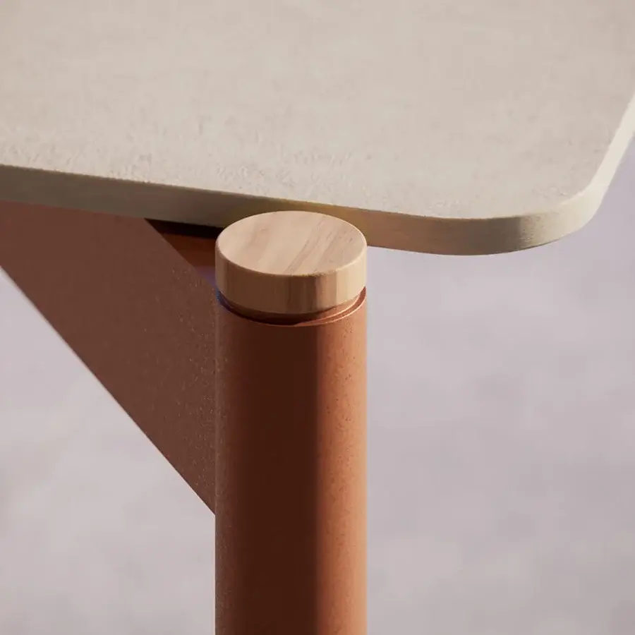 Distinguished Atmosphera Heritage table with a smooth matte gres tabletop and cylindrical aluminum legs accented with warm teak