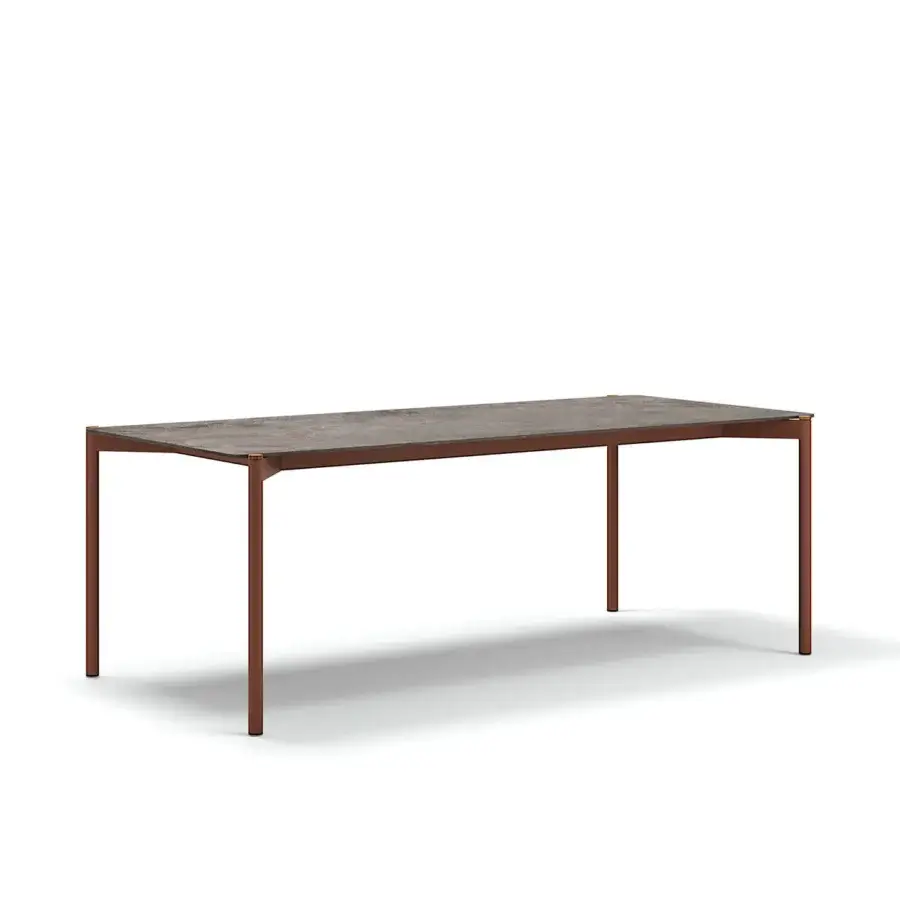 Distinguished Atmosphera Heritage table crafted with a textured gres tabletop and cylindrical aluminum legs detailed in teak accents