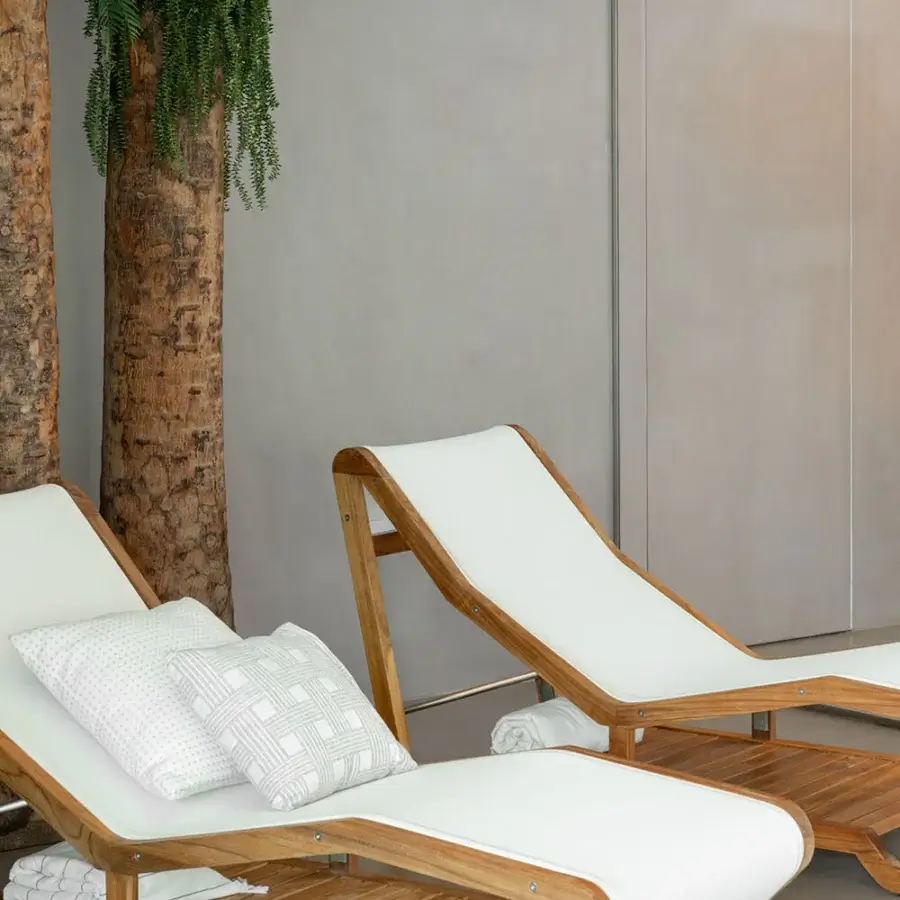 Elegant Atmosphera Infinity chaise lounge with durable Asian oiled TEAK and breathable white textilene surface crafted in brushed steel