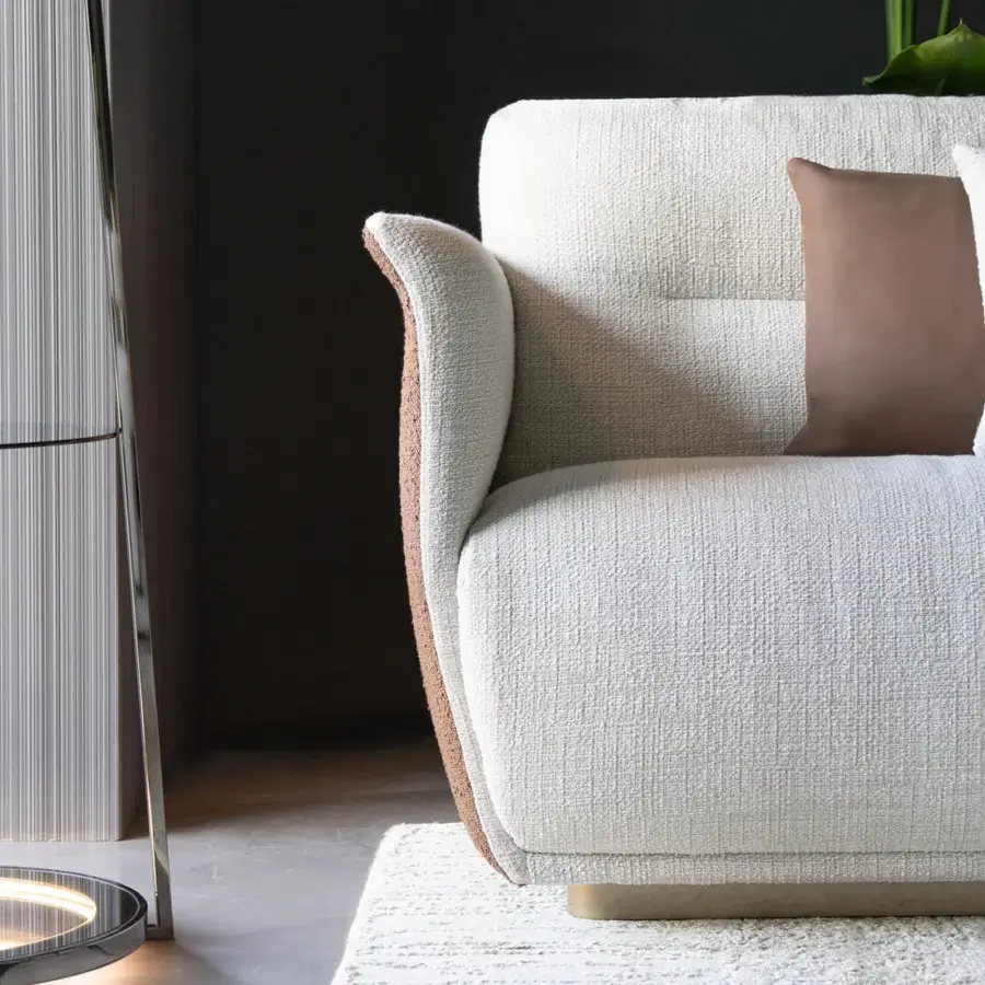 Exceptional Capital Mon Allure sofa with textured off-white fabric and warm brown accents built on a solid wooden frame with a metallic plinth