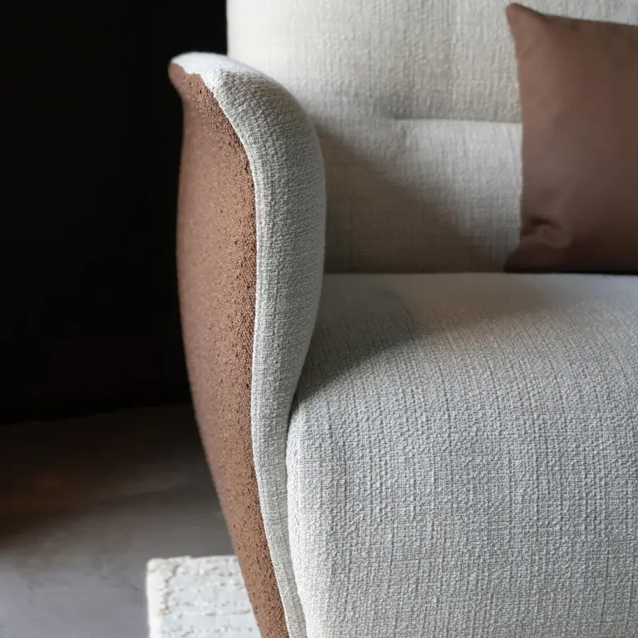 Distinguished Capital Mon Allure sofa crafted in textured off-white fabric with a quilted brown exterior and plinth base