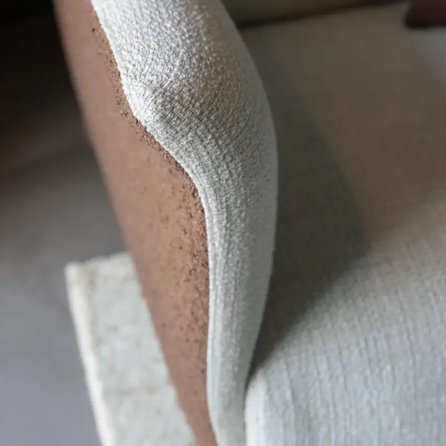 Elegant Capital Mon Allure sofa built with textured beige fabric and white detailing upon a metal-finished plinth base