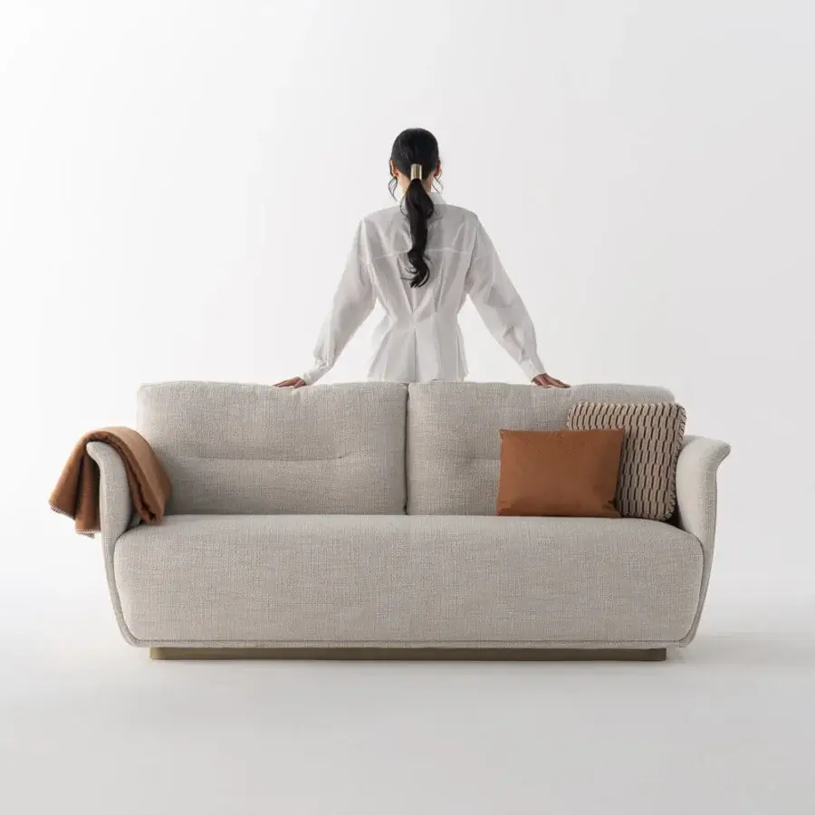 Captivating Capital Mon Allure sofa built with textured neutral beige fabric and a dark satin-finish wooden plinth base