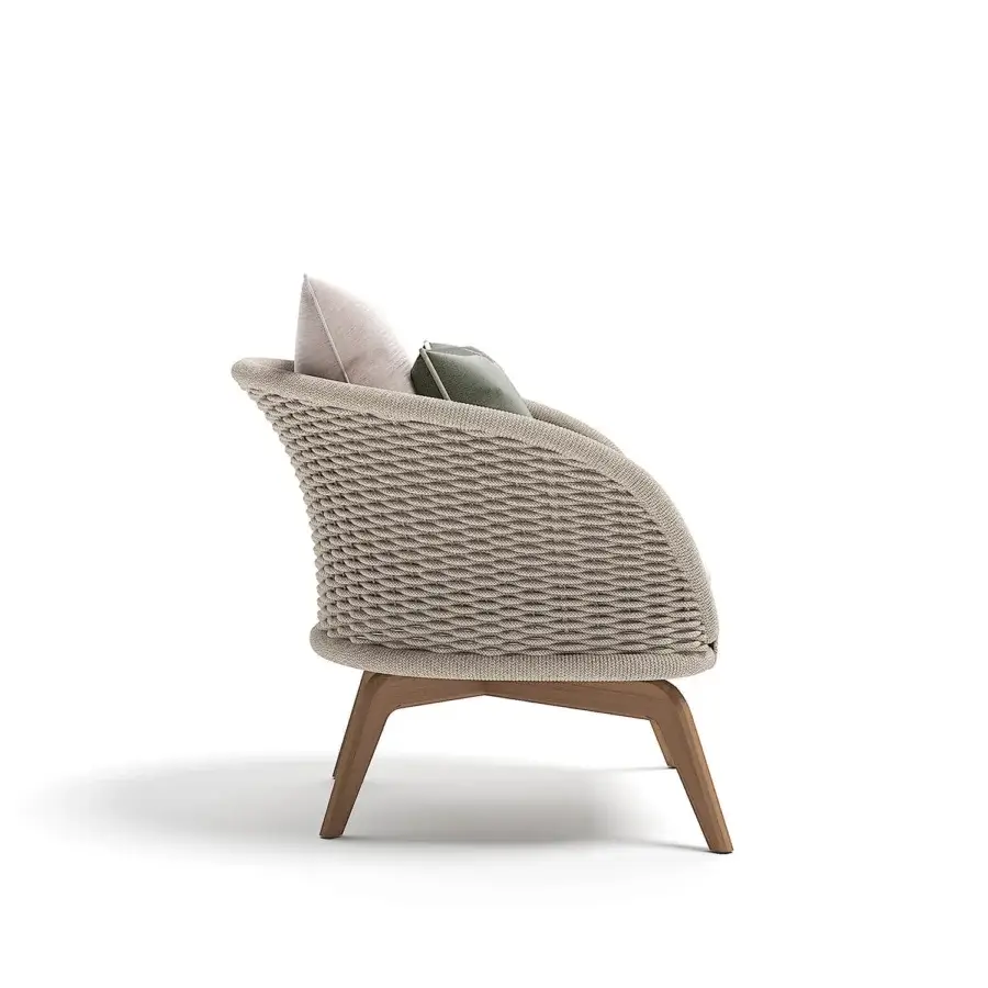 Elegant Atmosphera Ludo lounge chair with a sculpted Teak wood base and hand-woven beige textile backrest accented with muted cushions