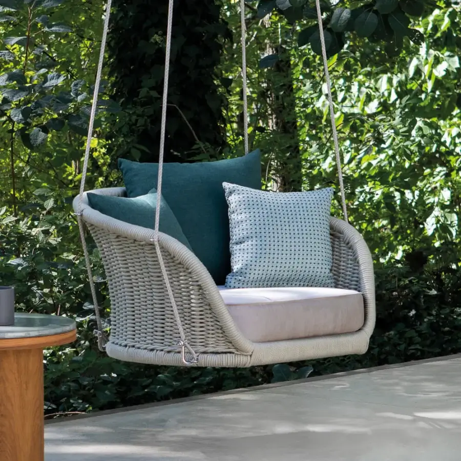 Distinctive Atmosphera Ludo swing with sculpted resin wicker and comfortable teal gray cushions offers weightless luxury for open-air living