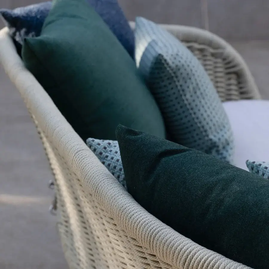 Elegant Atmosphera Ludo swing with muted gray hand-woven texture and plush teal navy cushions crafted for luxurious outdoor living