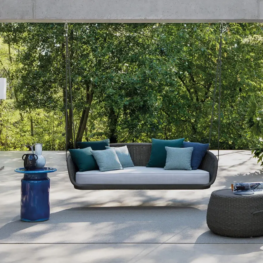 Distinctive Atmosphera Ludo hanging sofa with hand-woven rope frame and comfortable cushions in teal, blue, and lighter blue-green tones