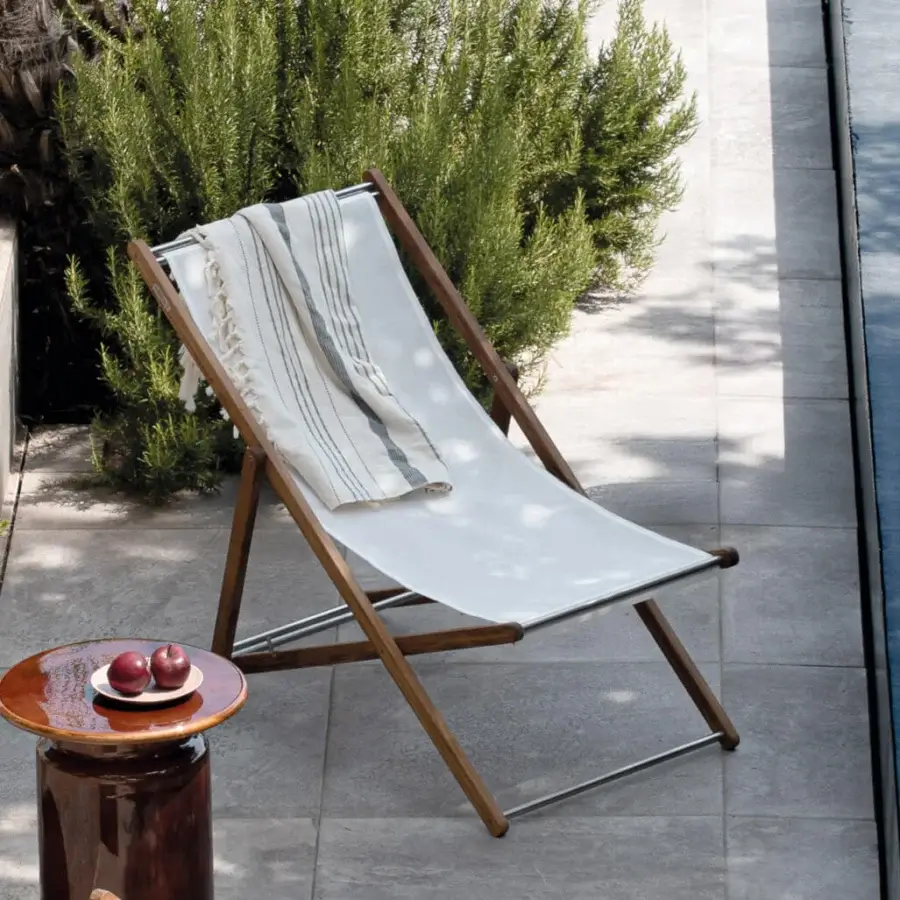 Distinguished Atmosphera Nirvana deck chair with Asian teak frame, brushed steel accents, and breathable off-white textilene seat, oil finish