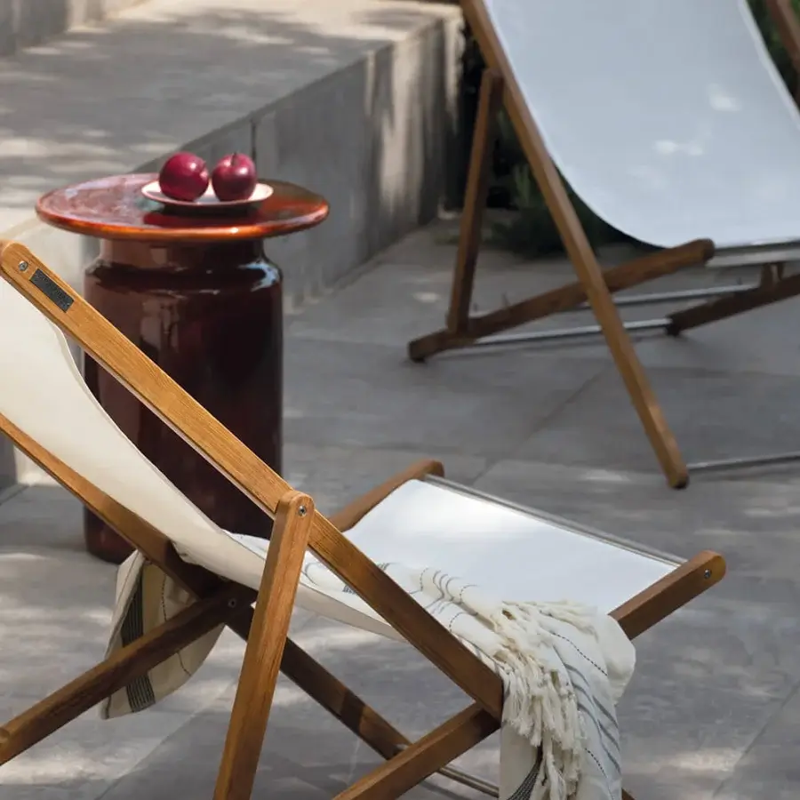 Lavish Atmosphera Nirvana deck chair built with Asian teak and white textilene, finished with an oil treatment