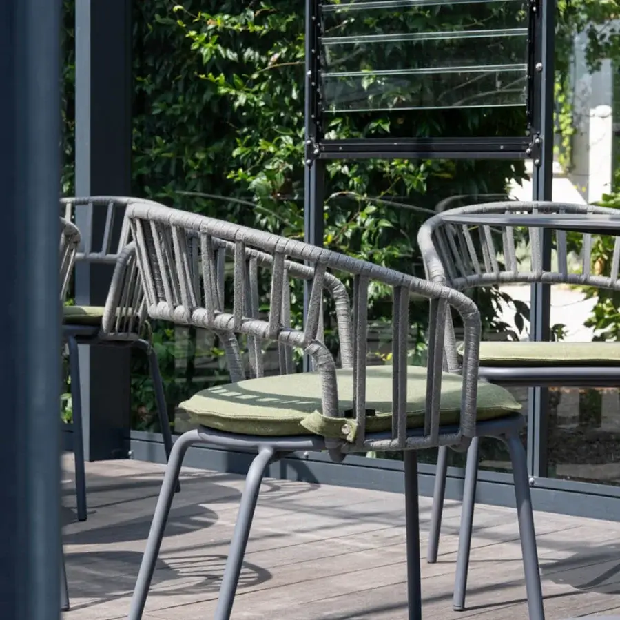 Distinctive Atmosphera Onda armchair with braided backrest and curved silhouette crafted in metal with muted olive green textile and matte grey finish
