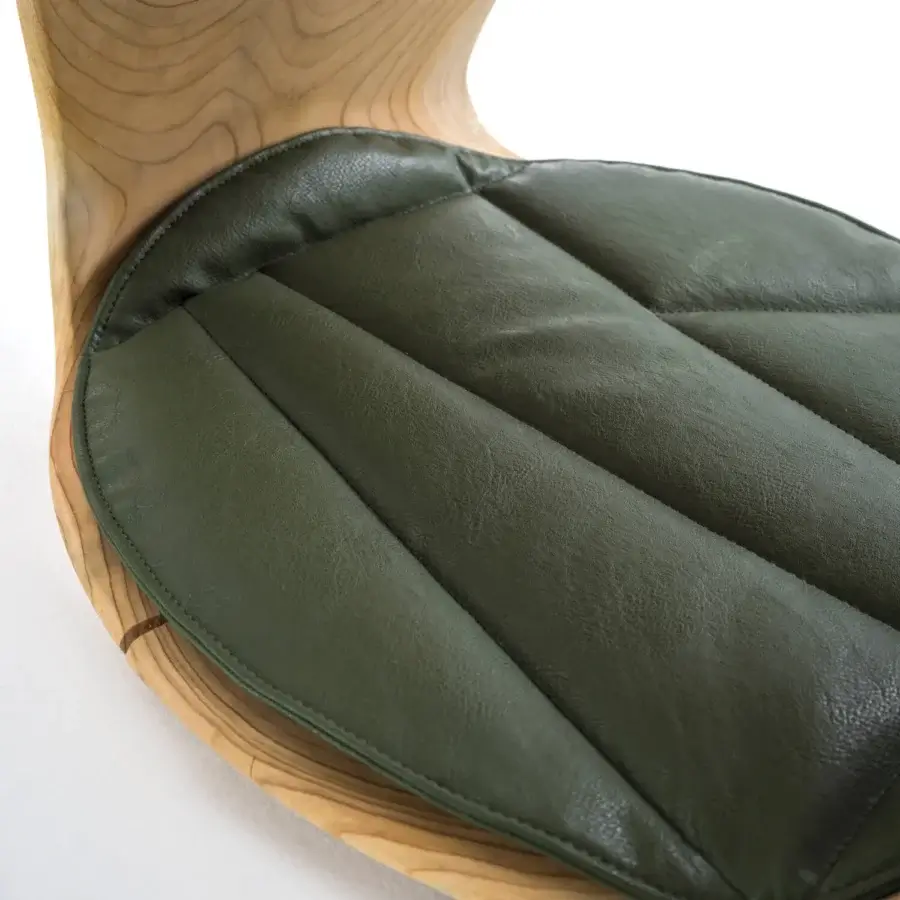 Distinguished Riva 1920 Geppo stool crafted from scented Cedar of Lebanon with a dark olive-green quilted cushion and satin finish