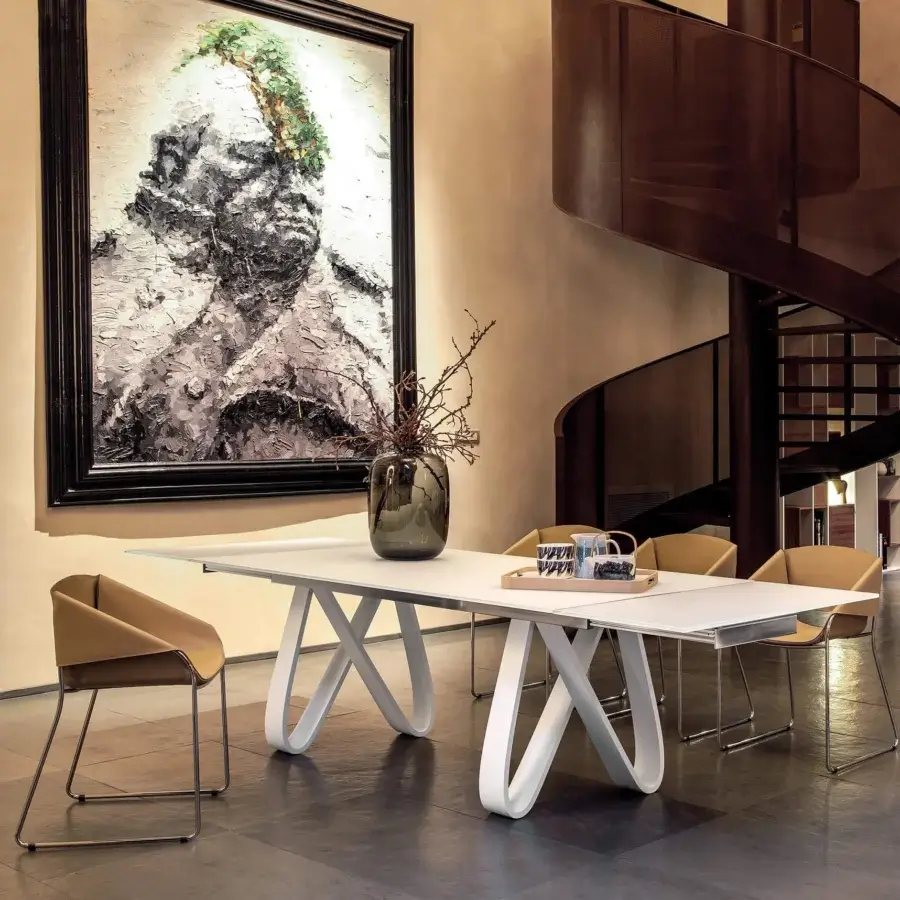 Distinguished Tonin Casa Butterfly Ext table crafted in light travertino with white-coated metal, showcasing graceful curved legs