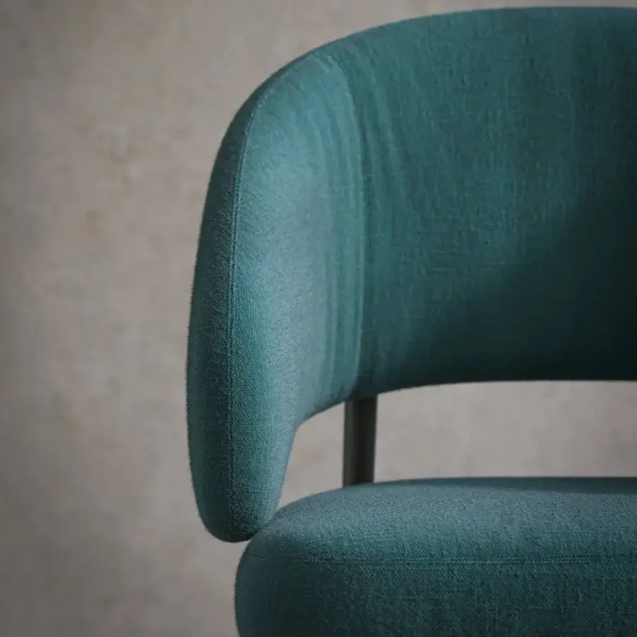 Distinguished Tonin Casa Astra armchair with softly curved silhouette and deep teal textile upholstery built with a sleek painted metal base