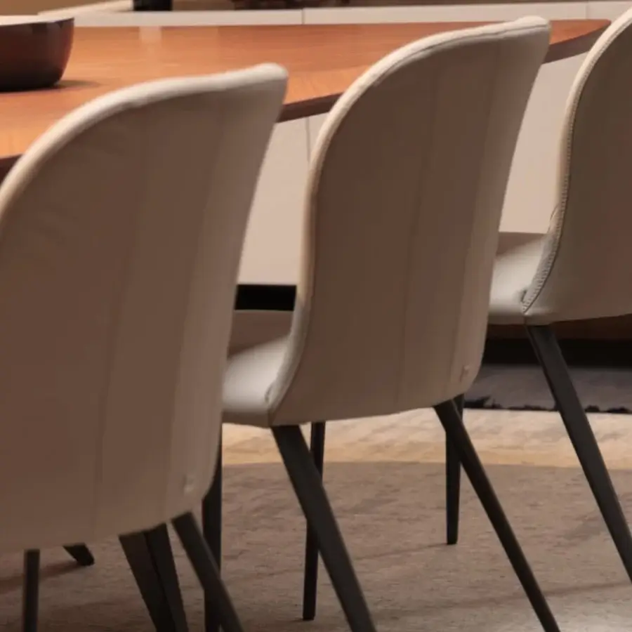 Sophisticated Tonin Casa Bustier chair with neutral beige textile upholstery and smooth satin lacquered metal structure