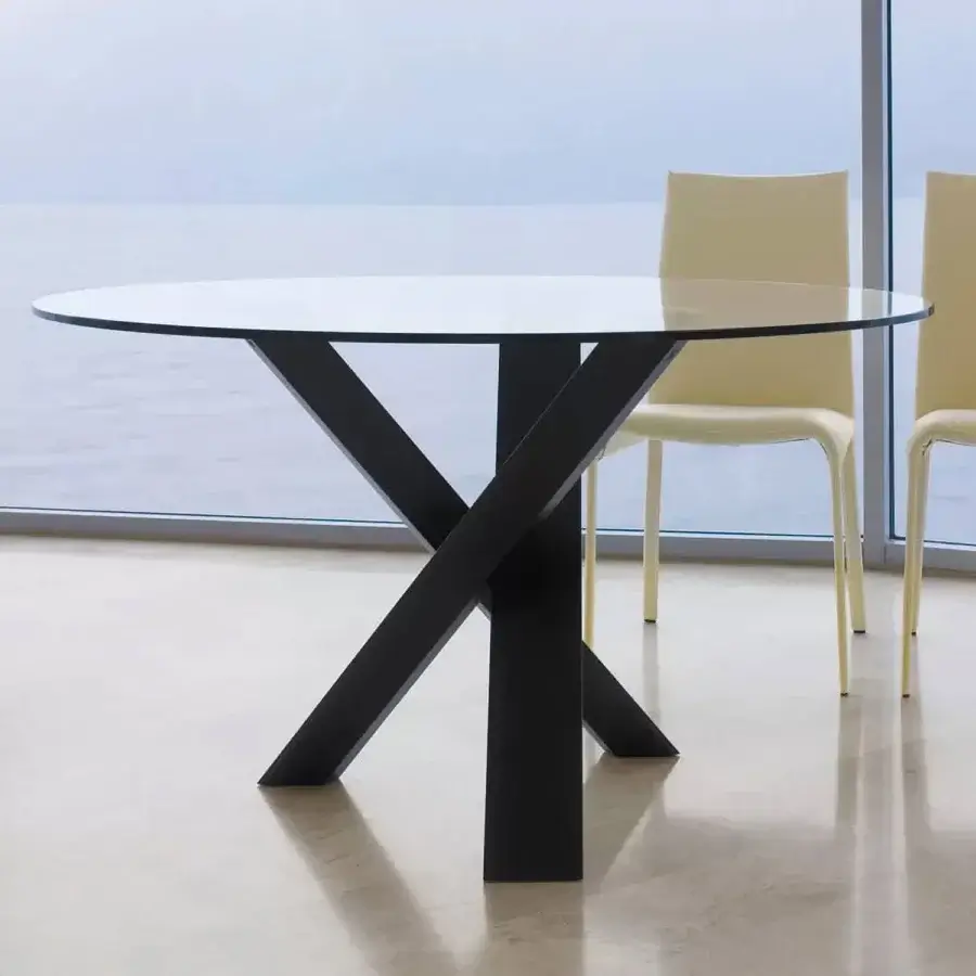 Elegant Ivano Antonello Italia Resort dining table with clear tempered glass and dark matte wood base crafted with an X-shaped support