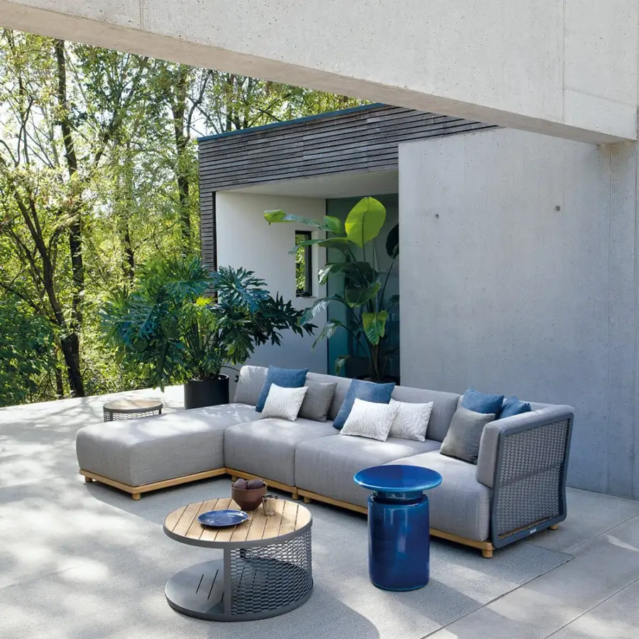 Captivating Atmosphera Switch coffee table with a warm wood tabletop encircled by woven synthetic material and a glossy blue metal base