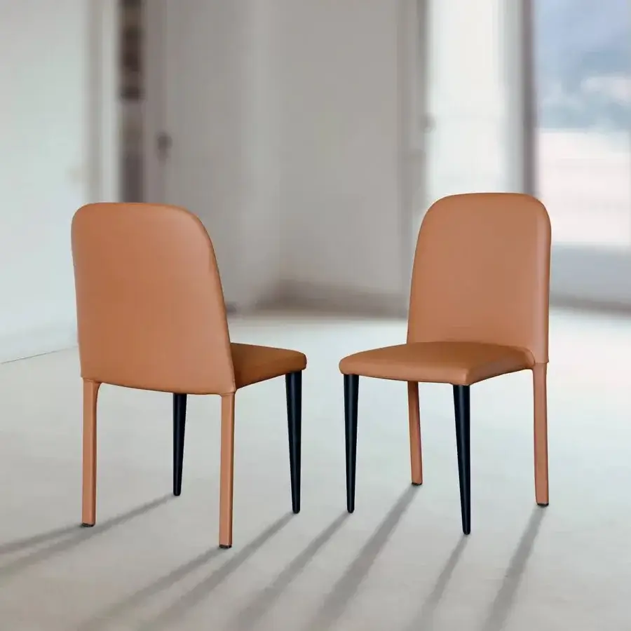 Sophisticated Ivano Antonello Italia Igorina dining chair with warm orange-brown leather upholstery and sleek dark-toned metal legs