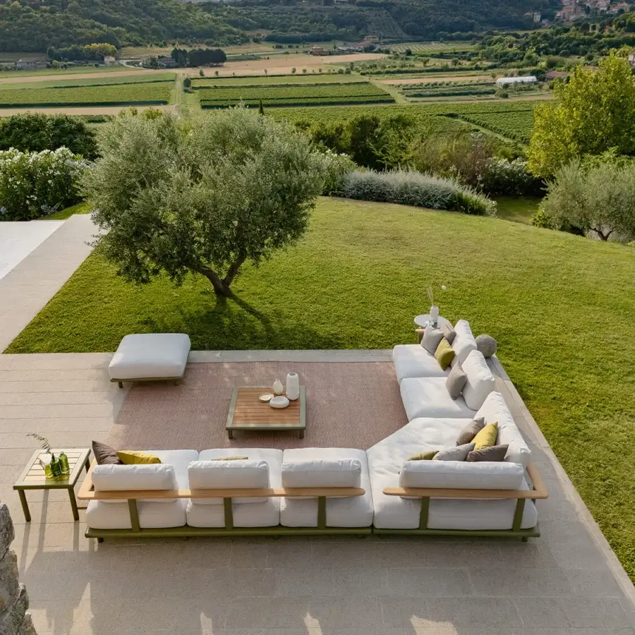Exceptional Atmosphera Bliss sectional with a gently curved design, off-white textile upholstery and Gesso aluminum frame with natural teak armrests